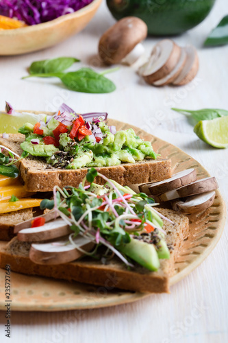 Selection of avocado toasts on grain bread. Healthy plant-based food