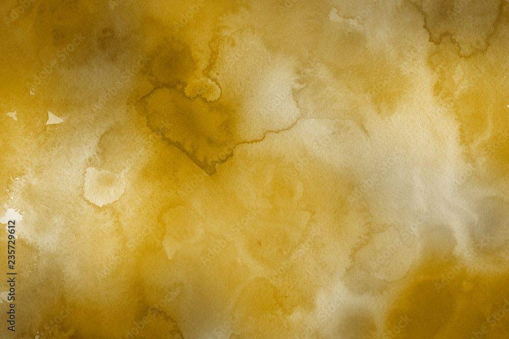 Gold watercolor texture with abstract washes and brush strokes on the white paper background. Gold watercolor texture with abstract washes and brush strokes on the white paper background.