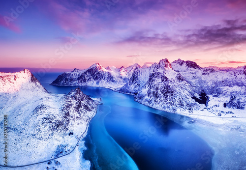 Aerial view at the Lofoten islands, Norway. Mountains and sea during sunset. Natural landscape from air at the drone. Norway at the winter time