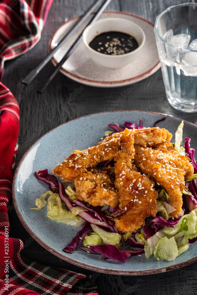 Salad with warm glazing chicken, sprinkled with sesame seeds. Chinese cuisine. Asian culture Salad with warm glazing chicken, sprinkled with sesame seeds. Chinese cuisine. Asian culture