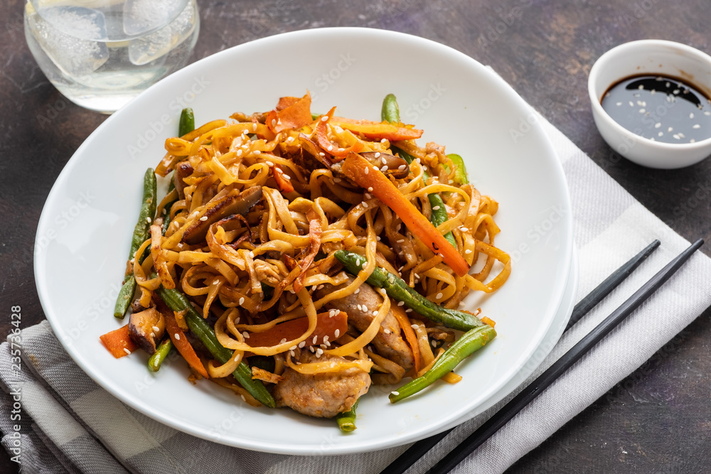 Asian noodles with pork in teriyaki sauce, with green beans, carrots and shiitake mushrooms. Asian noodles with pork in teriyaki sauce, with green beans, carrots and shiitake mushrooms.