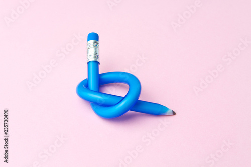 Flexible pencil on pink background. Bent pencils. Flexible business concept.