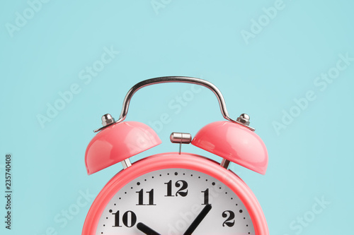 Red alarm clock on blue background photo