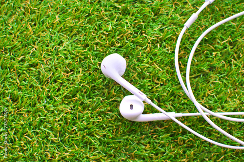 Headsets on a green artificial lawn. Sinthetic grass. photo