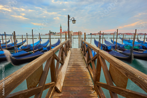 Condolas and wooden pier in Venice