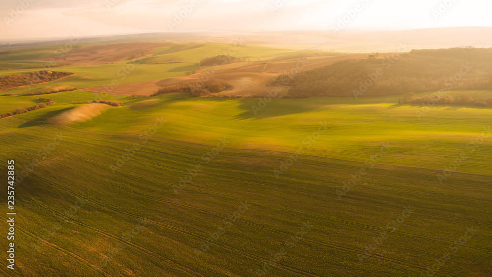 Aerial landscape with green field, sunset light