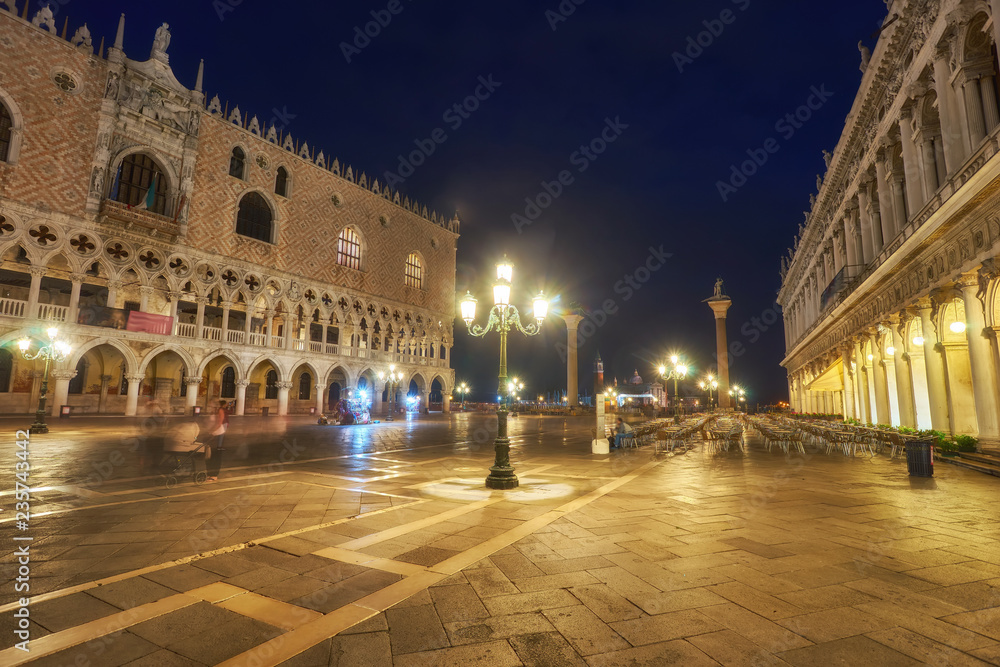 Bell tower and historical buildings at night at Piazza San Marco in Venice