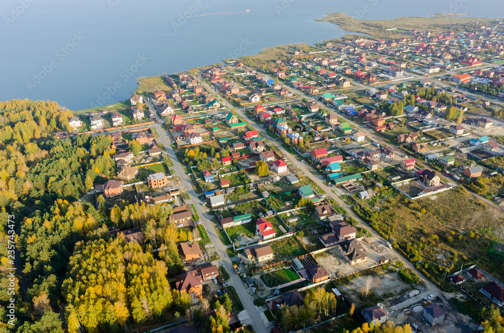 Aerial view of houses on lake bank. Tyumen. Russia