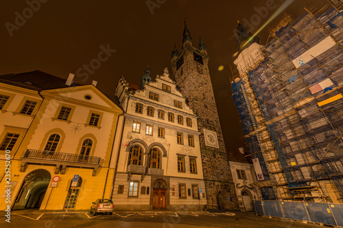 Klatovy old city hall and Black tower in autumn night with orange sky