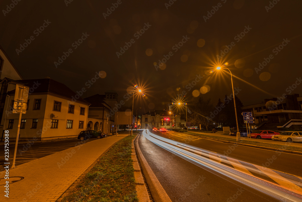 Klatovy new street with cars in autumn night with orange sky