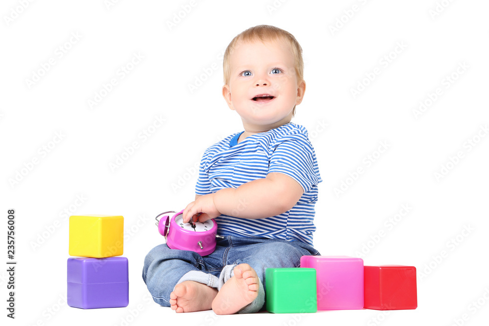 Baby boy with alarm clock and toy cubes isolated on white background Baby boy with alarm clock and toy cubes isolated on white background