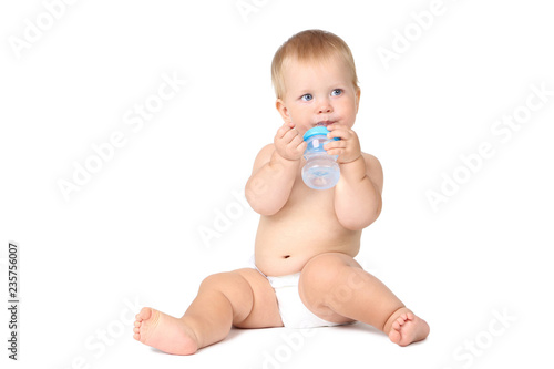 Baby boy drinking water from bottle isolated on white background © 5second