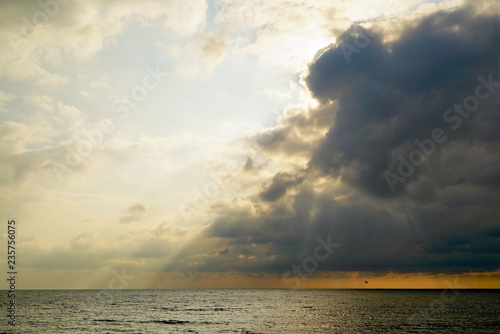 The sun breaks through the clouds above the sea . Tarhankut. Crimea © amarinchenko106