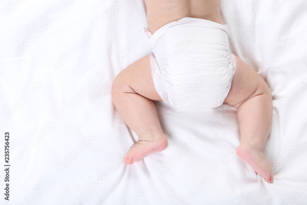Little boy in diaper lying on white bed Little boy in diaper lying on white bed