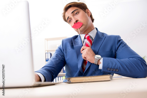 Funny bisinessman with fake lips in the office photo