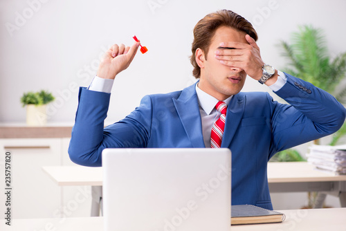 Businessman throwing dart in business concept photo