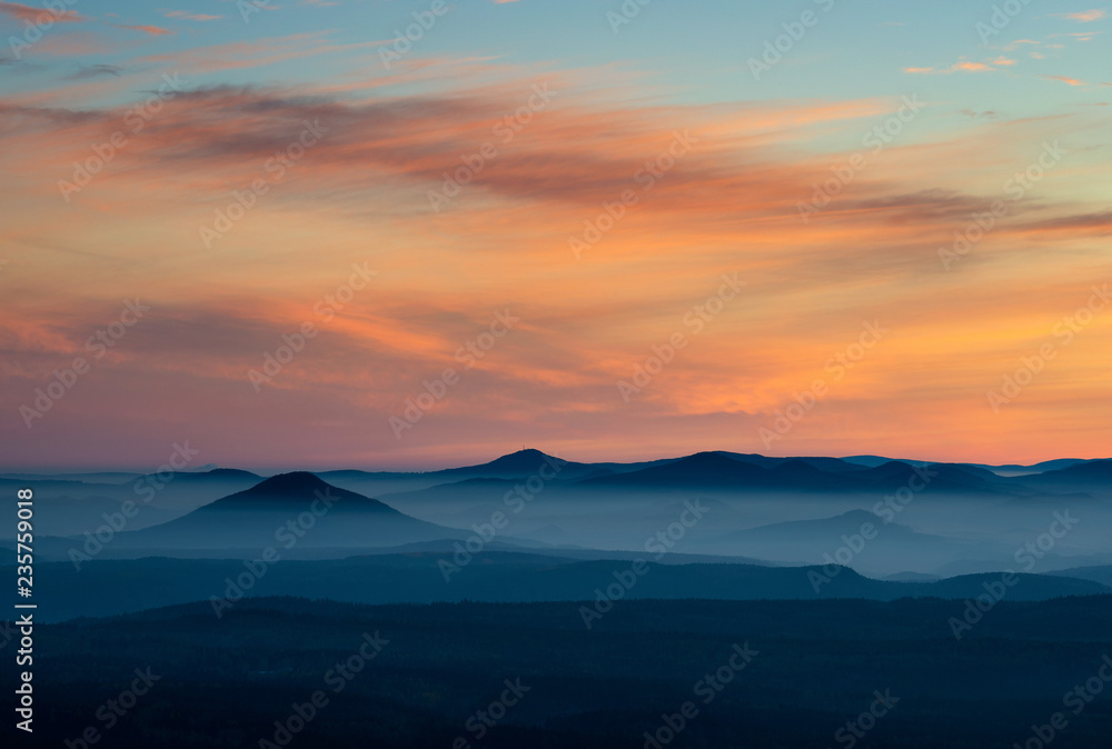 Dramatic sunrise over beautiful mountain peaks. Decinsky Sneznik, Czech republic