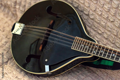 Close up of modeern black musical instrument mandolin photo