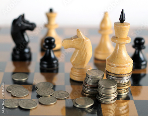 Pieces on chess board with money.
