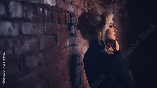 Attractive young blonde in black turtleneck. Beautiful woman with stylish make-up