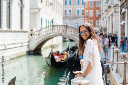 Young girl posing on camera in venetian streets © teksomolika