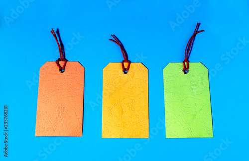 Pastel price tags, discount concept. Paper craft Christmas theme. Christmas sales concept.  Colourful pastel Christmas bags.  Shopping concept. Orange, yellow, green sales tags. Copy space