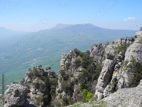 Beautiful mountain landscape with sheer cliffs. Distant mountain plateaus in a blue haze. Crimean mountains. © Deilline