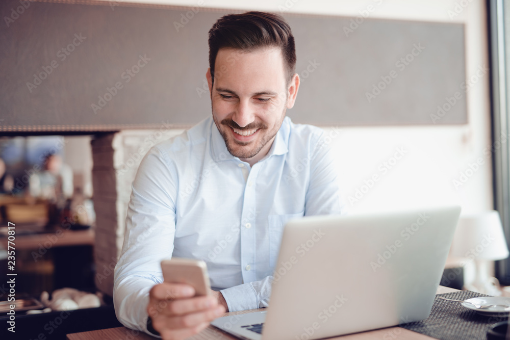 Young man using laptop indoors Young man using laptop indoors