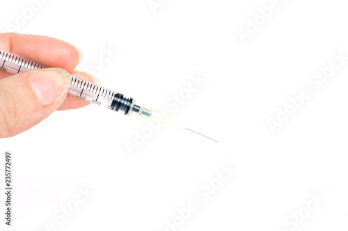 Female hands prepare an insulin syringe for work on a white background