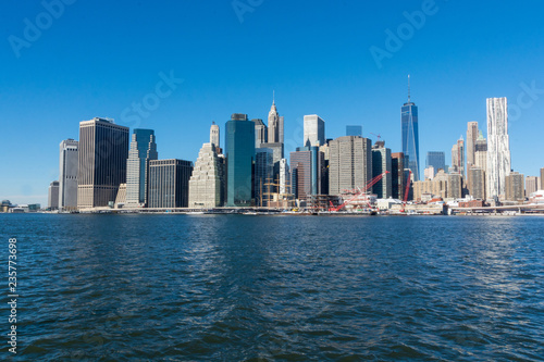 Manhattan Island viewed from Brooklyn on a cold and sunny winter day with cloudless blue sky