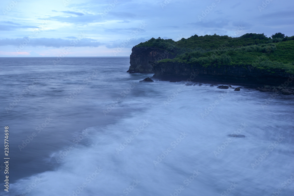  blue ocean under cloudy sky in a bad weather long exposure photography