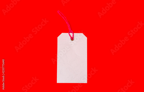 White price tag on red background. Plain price tag.