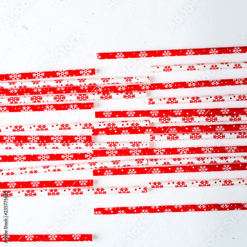 Drinking straws for party on white background. Top view of colorful paper straws for cocktails. Place for text, copy space.