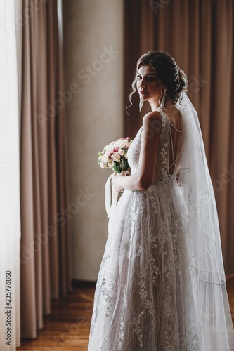 Gorgeous bride in a beautiful dress. Morning newlyweds.