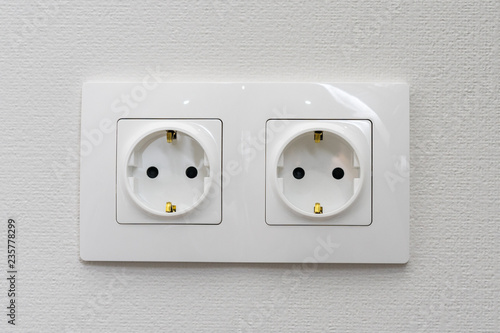 double electrical socket on white wallpaper