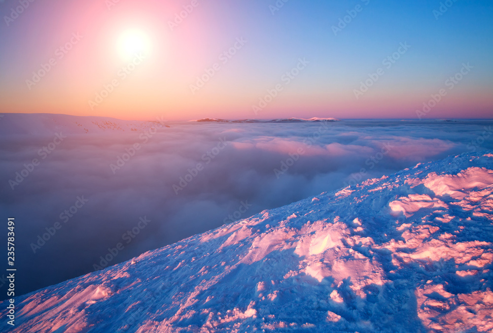 Magnificent dawn in the winter snowy mountains aerial view