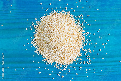 raw quinoa seeds on a blue wooden backgpound - Chenopodium quinoa photo