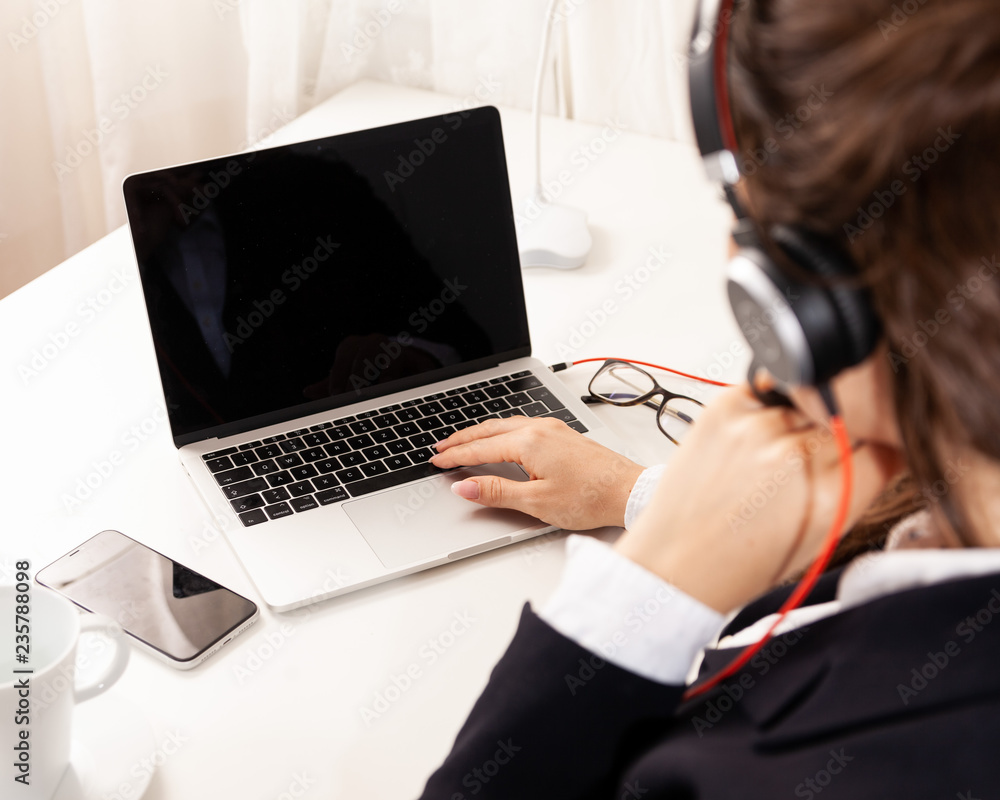 over the shoulder shot of young business woman in home office with headset e-learning call-center support software over the shoulder shot of young business woman in home office with headset e-learning call-center support software
