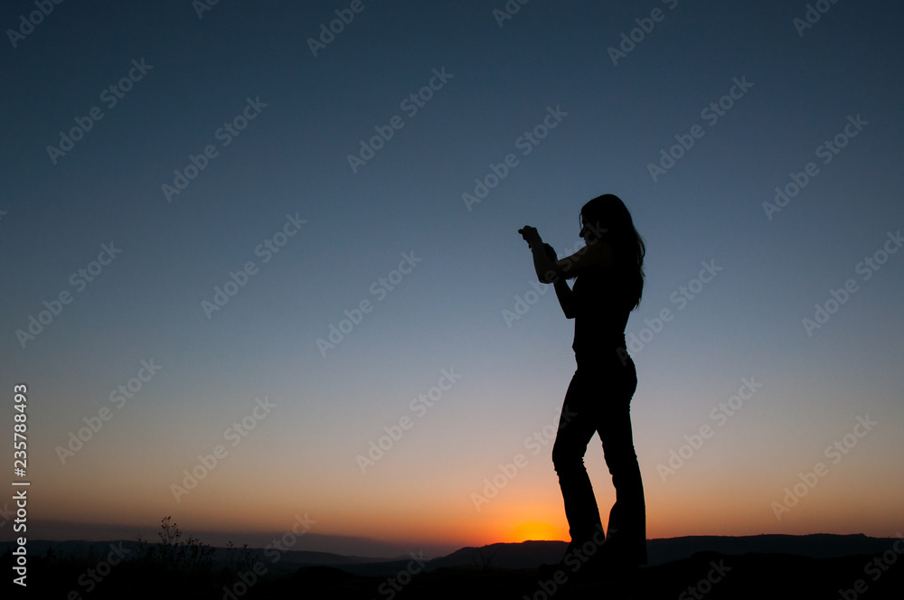 silhouette of woman on sunset