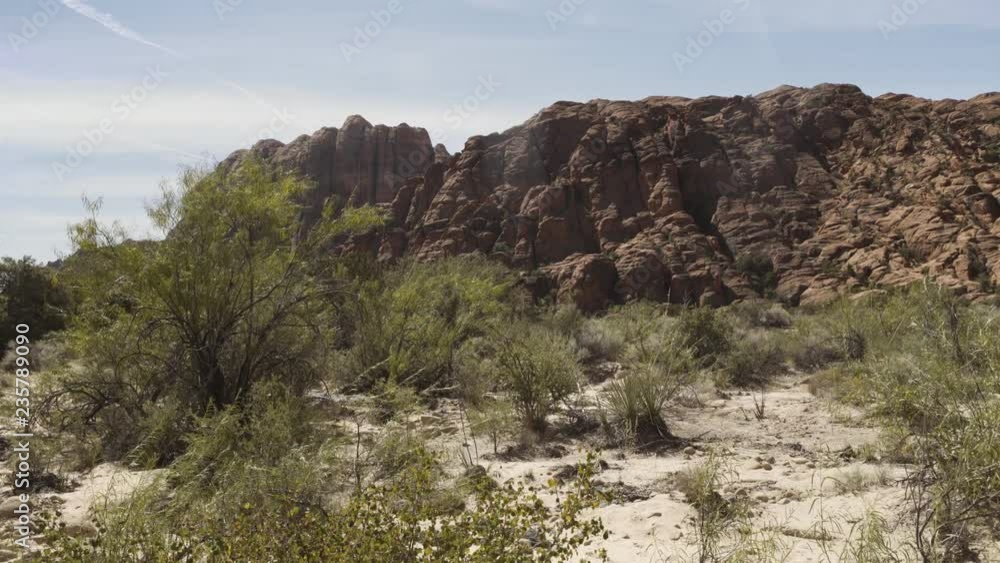 Slow motion walking in a desert with rocks and dried herbs Slow motion walking in a desert with rocks and dried herbs