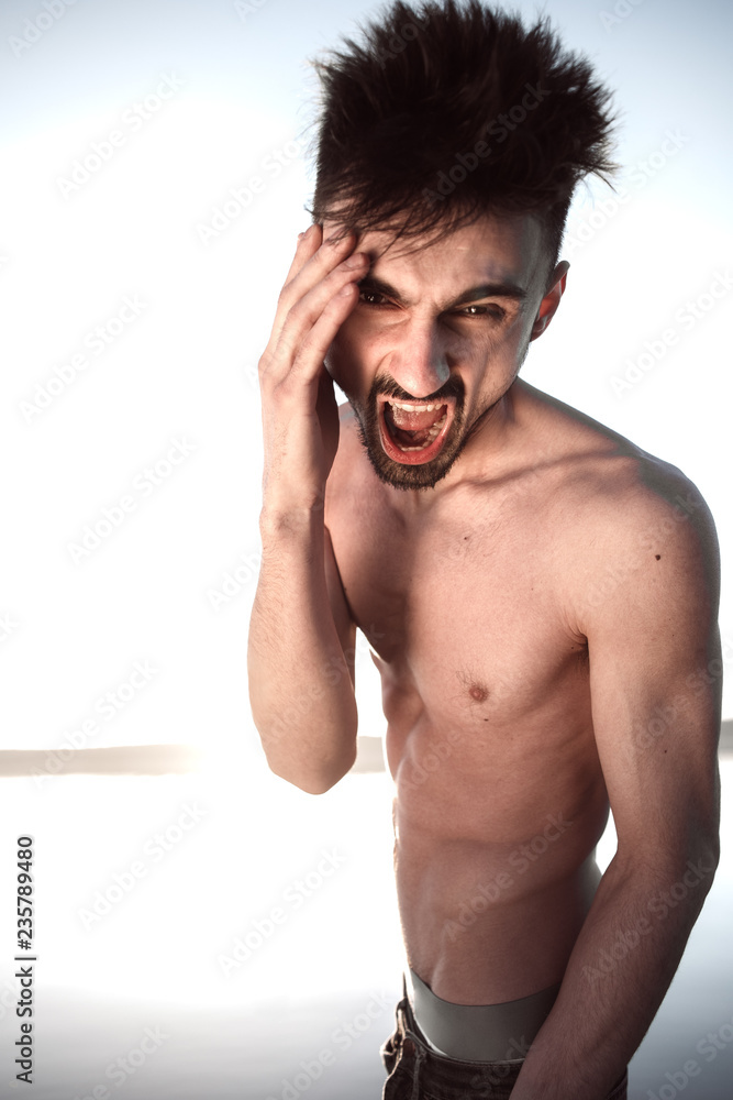 Fototapeta premium the guy with the naked torso screams