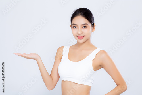 Portrait asian woman beautiful body diet with fit presenting something empty copy space on the hand isolated on white background, model girl weight slim with calories, health and wellness concept.