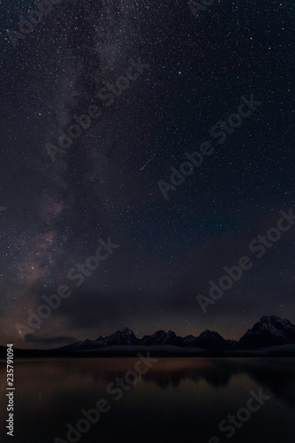 The Milky Way and a meteor in June, above Jackson Lake, Grand Teton NP, Wyoming © Kerrick