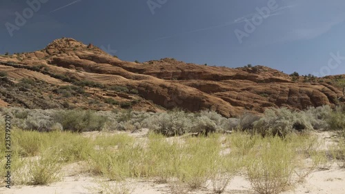 Red rock in the desert with white sand photo