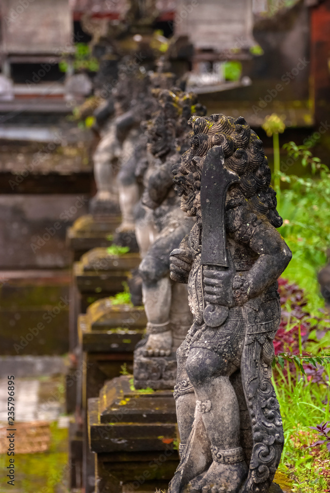 Balinese Stone Statuary at the Hindu Temple. Ancient stone carvings depicting the battle between good and evil meant to protect the temple and the worshipers.