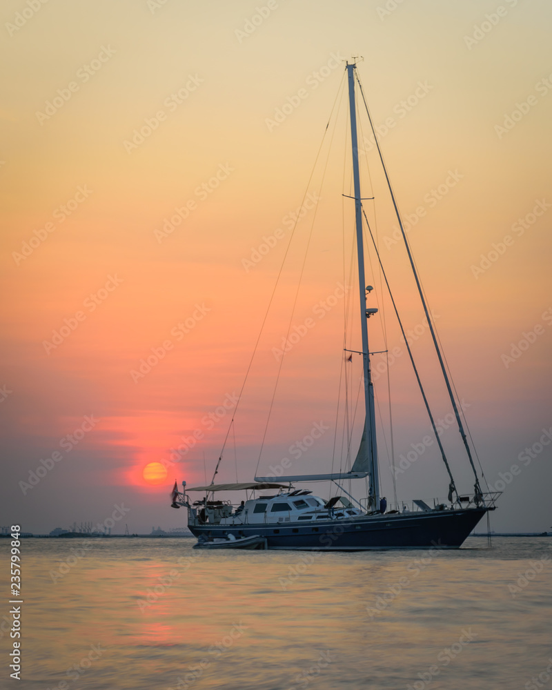 A boat with a colorful sunset sky at Mutiara Beach