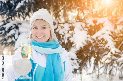 Beautiful attractive blonde with a glass of champagne in her hands celebrates the New Year