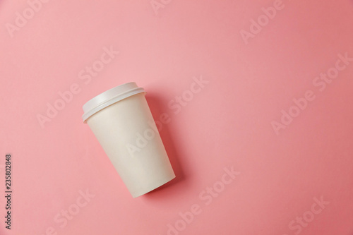 Simply flat lay design paper coffee cup on pink pastel colorful trendy background. Takeaway drink container. Good morning wake up awake concept. Template of drink mockup. Top view copy space