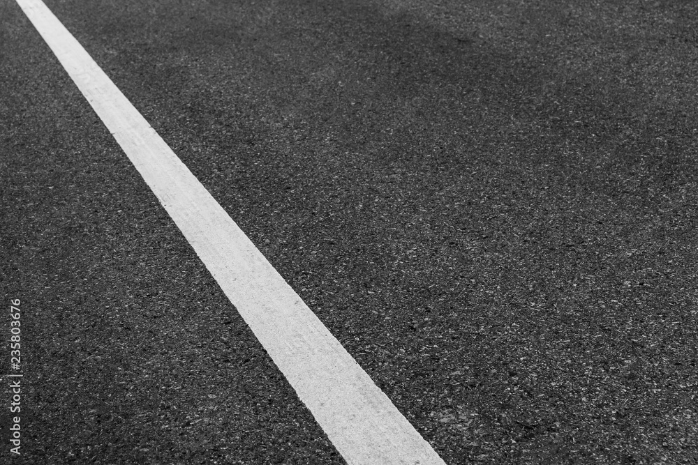 Asphalt road texture background, white guidelines on street.