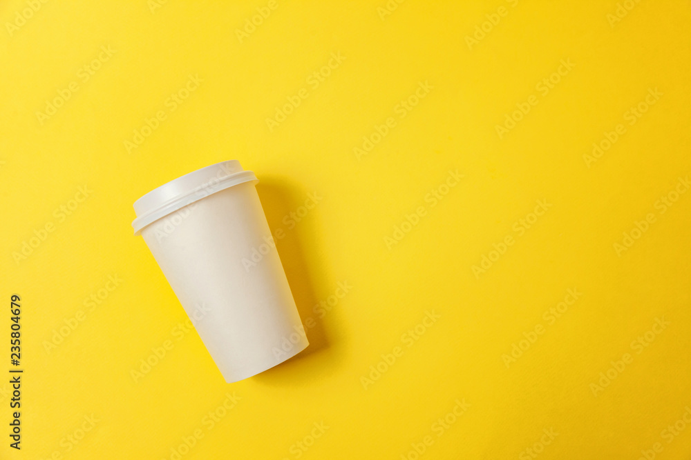 Simply flat lay design paper coffee cup on yellow colorful trendy background. Takeaway drink container. Good morning wake up awake concept. Template of drink mockup. Top view copy space Simply flat lay design paper coffee cup on yellow colorful trendy background. Takeaway drink container. Good morning wake up awake concept. Template of drink mockup. Top view copy space